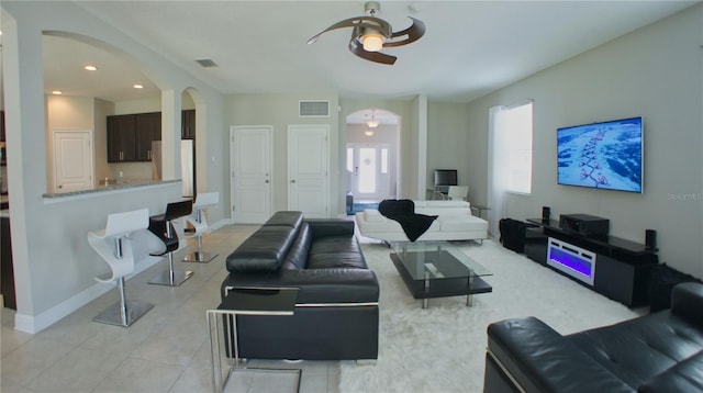 tiled living room with ceiling fan