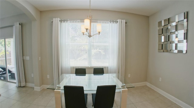 dining space with a chandelier and light tile patterned flooring