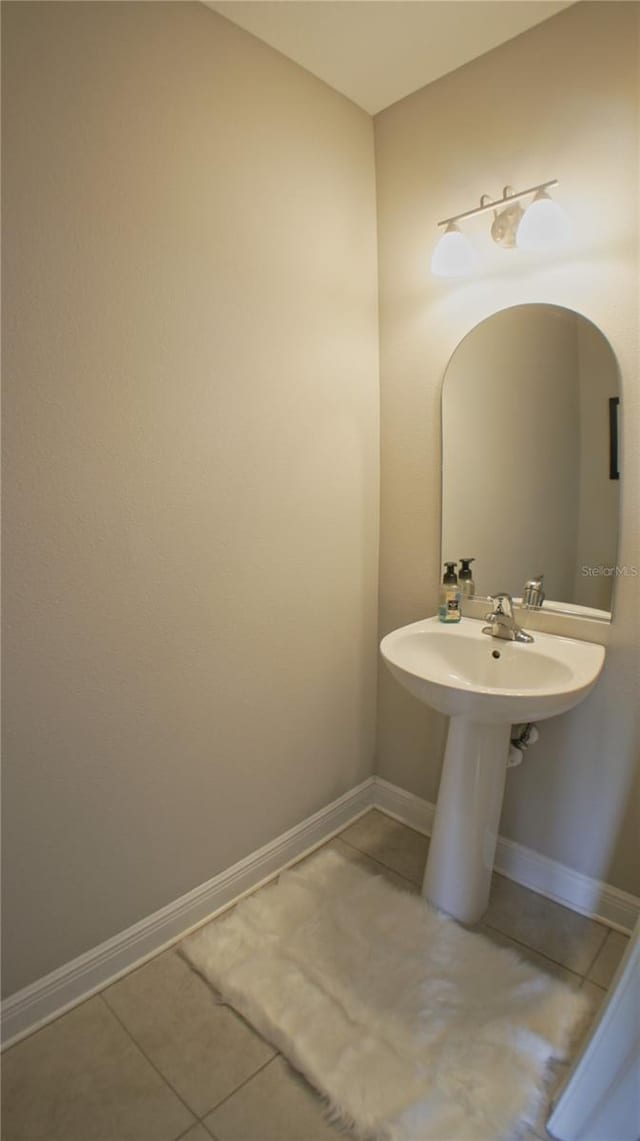 bathroom with tile patterned flooring and sink