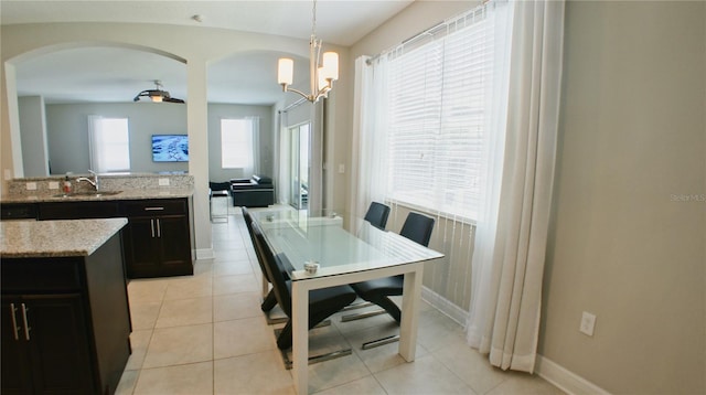 dining area featuring sink and light tile patterned flooring