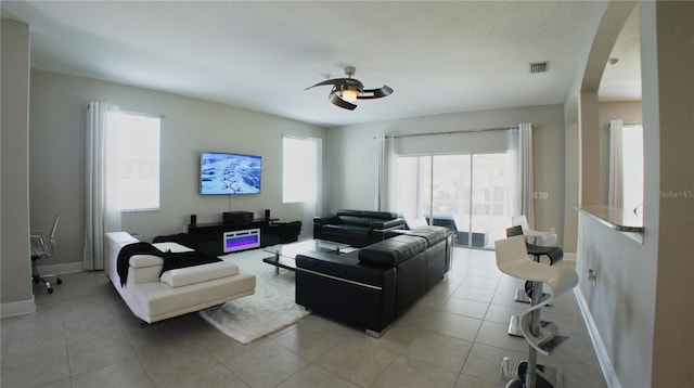 tiled living room featuring a wealth of natural light