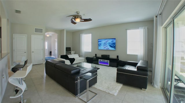 living room with plenty of natural light, light tile patterned floors, and ceiling fan