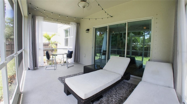 sunroom / solarium featuring vaulted ceiling