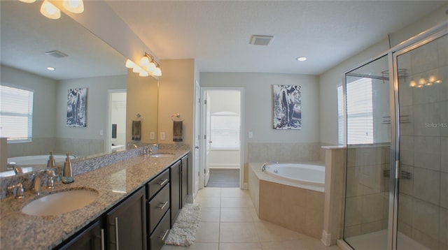 bathroom featuring vanity, independent shower and bath, and tile patterned flooring