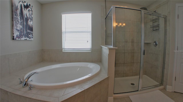 bathroom featuring shower with separate bathtub