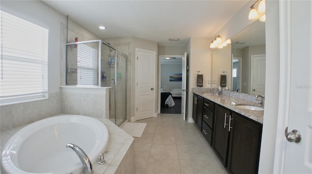 bathroom with tile patterned floors, separate shower and tub, and vanity