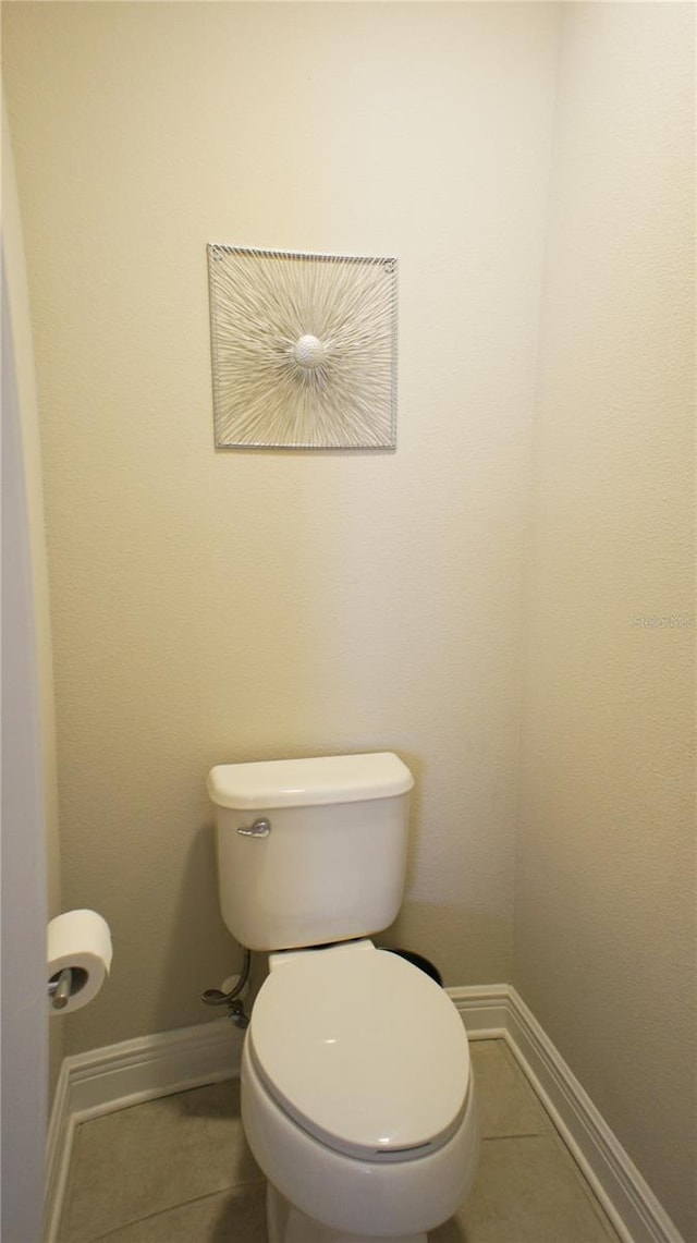 bathroom with tile patterned flooring and toilet