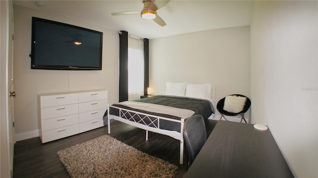 bedroom with dark hardwood / wood-style floors and ceiling fan