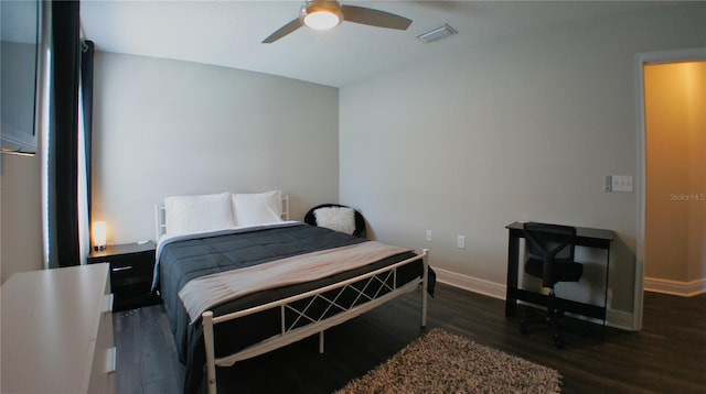 bedroom with ceiling fan and dark hardwood / wood-style flooring