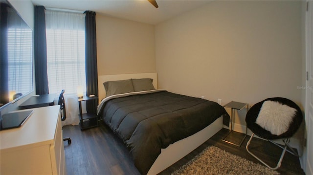 bedroom with dark wood-type flooring