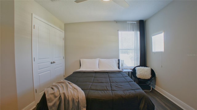 bedroom featuring hardwood / wood-style flooring, ceiling fan, and a textured ceiling