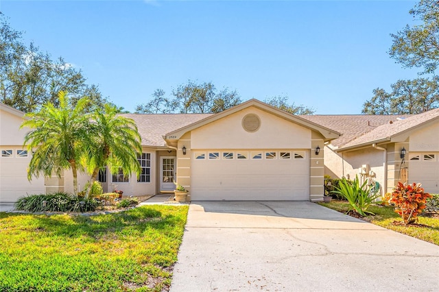 single story home featuring a garage and a front lawn