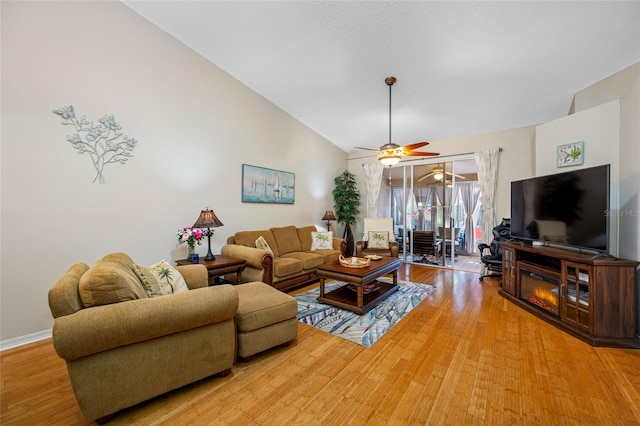 living room with ceiling fan, wood-type flooring, and high vaulted ceiling