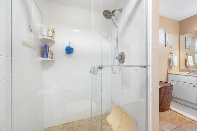 bathroom featuring vanity and a shower with door