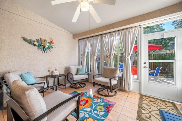 sunroom with ceiling fan and vaulted ceiling