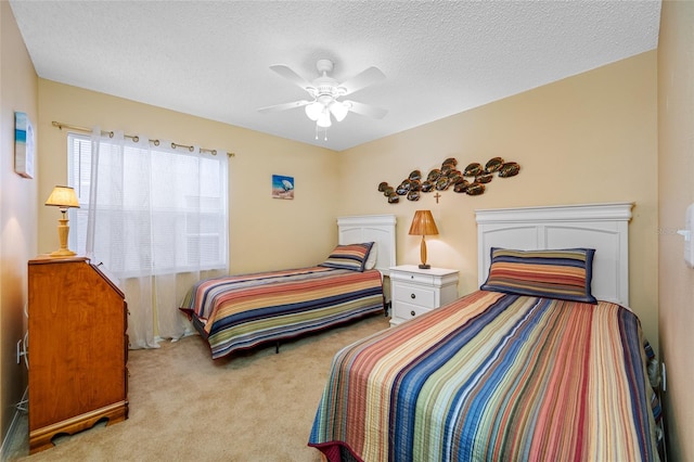 bedroom featuring ceiling fan, light carpet, and a textured ceiling