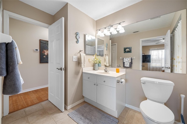 bathroom with tile patterned floors, vanity, and toilet