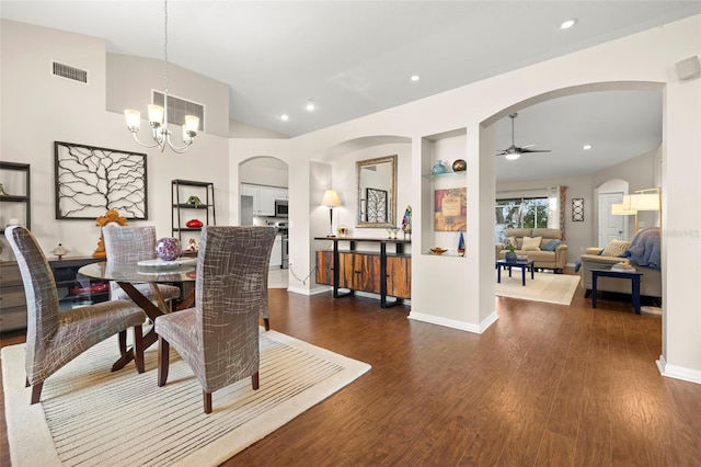 dining room featuring dark hardwood / wood-style flooring, ceiling fan with notable chandelier, and lofted ceiling