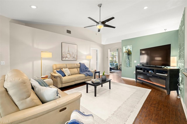 living room featuring hardwood / wood-style floors, vaulted ceiling, and ceiling fan