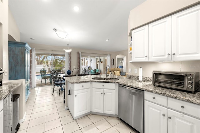 kitchen with sink, stainless steel dishwasher, kitchen peninsula, and white cabinets