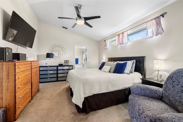 bedroom with vaulted ceiling, light colored carpet, and ceiling fan