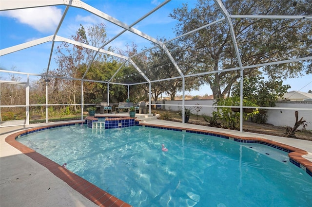 view of swimming pool featuring a patio area and glass enclosure