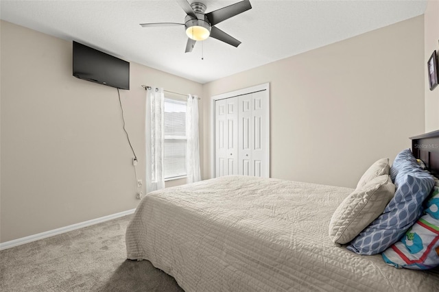 carpeted bedroom featuring a closet and ceiling fan