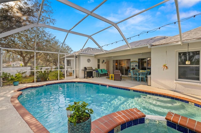 view of pool with area for grilling, a patio, and glass enclosure