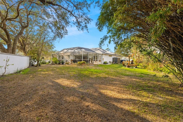 view of yard featuring glass enclosure