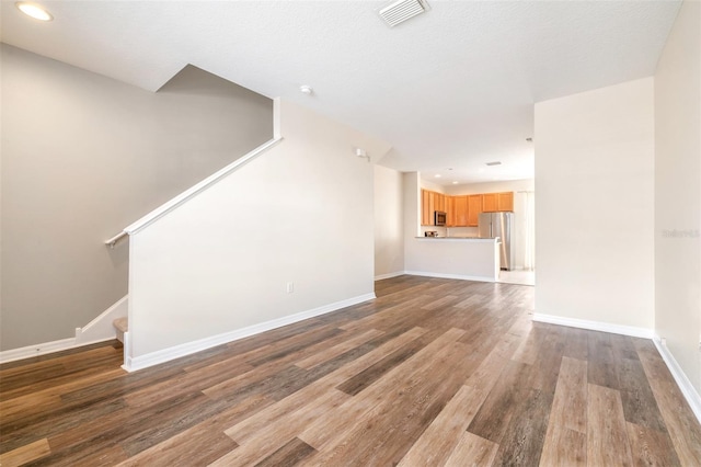 unfurnished living room with hardwood / wood-style flooring