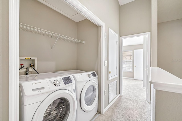 washroom with light colored carpet and washer and clothes dryer