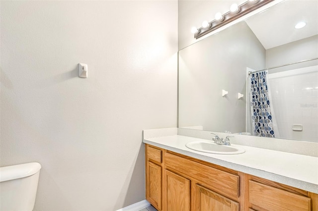 bathroom featuring walk in shower, vanity, and toilet