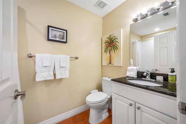 bathroom featuring vanity, tile patterned floors, toilet, and walk in shower