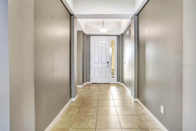 doorway to outside featuring light tile patterned flooring