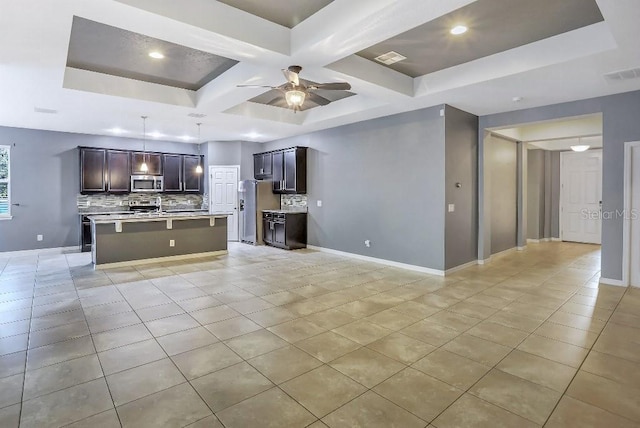 unfurnished living room featuring beamed ceiling, coffered ceiling, light tile patterned floors, and ceiling fan