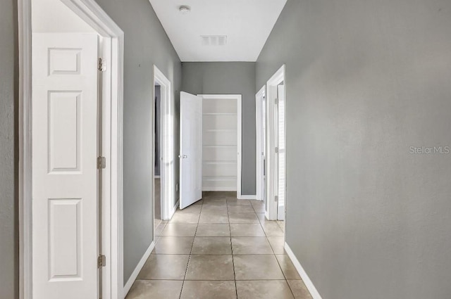 corridor featuring light tile patterned flooring