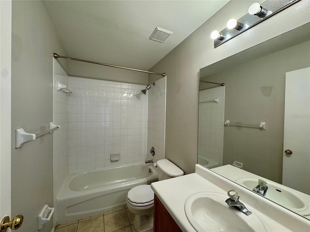 full bathroom featuring tile patterned flooring, vanity, tiled shower / bath combo, and toilet