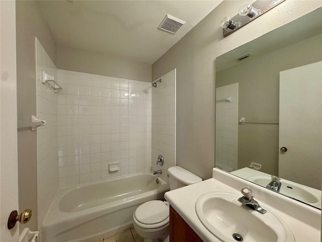 full bathroom with tiled shower / bath combo, vanity, and toilet