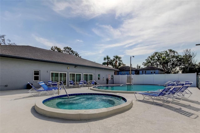 view of pool featuring a patio and a community hot tub