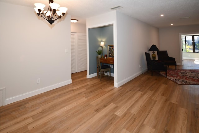 interior space with an inviting chandelier and light wood-type flooring