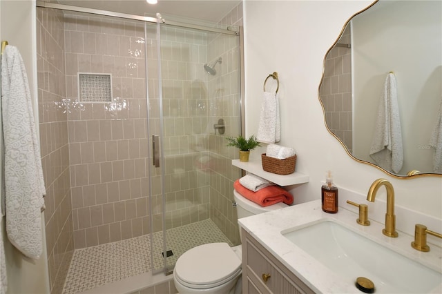 bathroom featuring vanity, toilet, and walk in shower