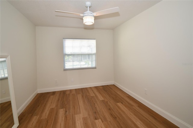 spare room with light hardwood / wood-style floors and ceiling fan