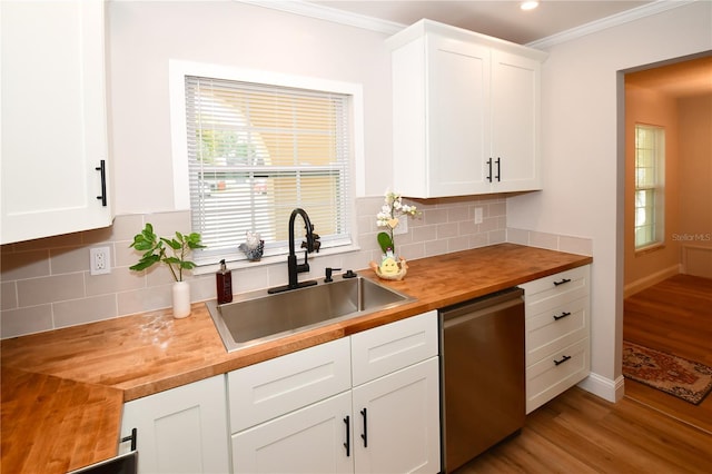 kitchen featuring butcher block countertops, sink, dishwasher, white cabinets, and light wood-type flooring