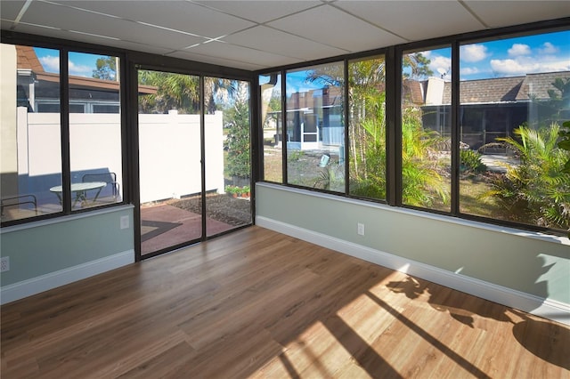 unfurnished sunroom with a drop ceiling