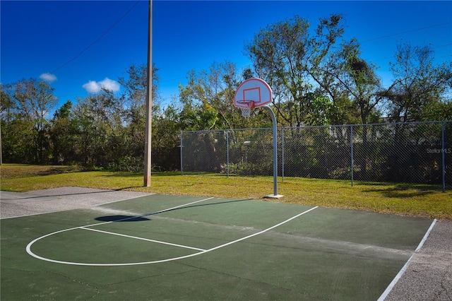 view of basketball court with a yard