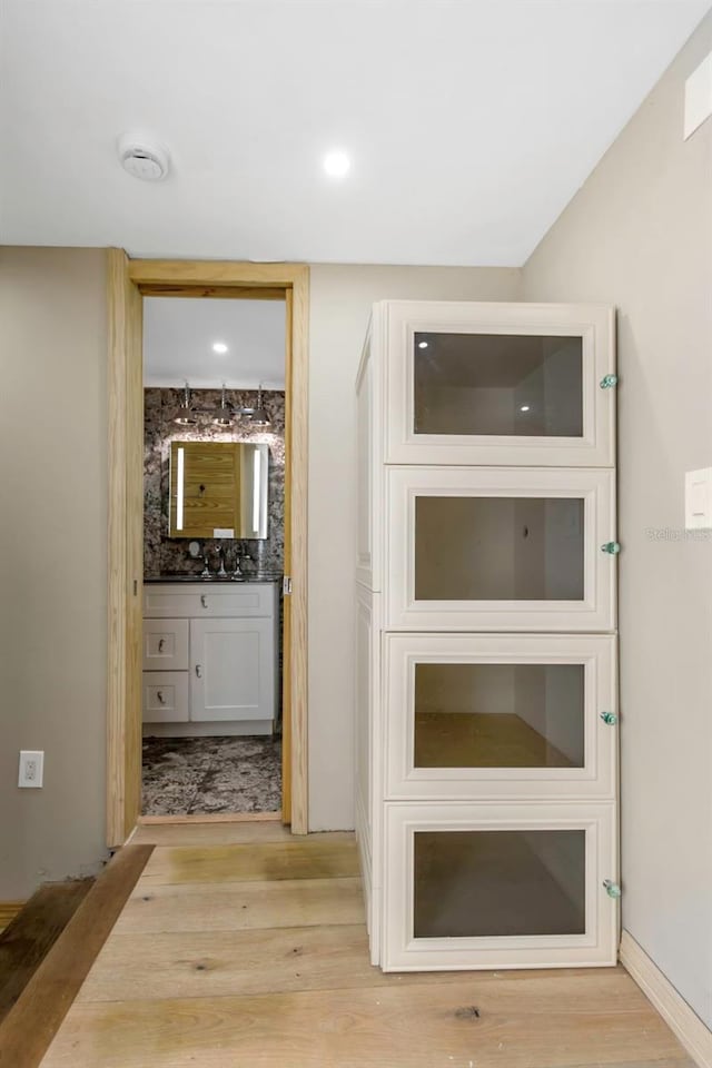 hall with light hardwood / wood-style floors