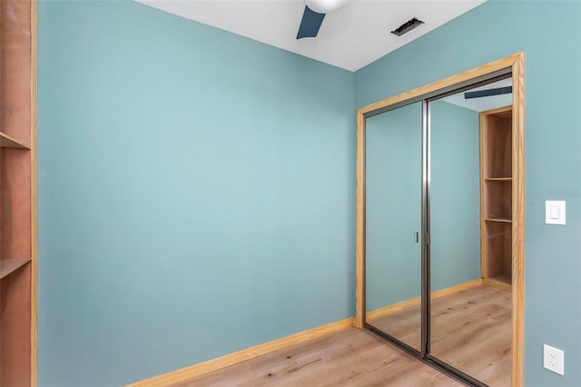 interior space with hardwood / wood-style flooring, a closet, and ceiling fan