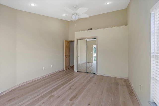 unfurnished bedroom featuring a closet, ceiling fan, and light hardwood / wood-style flooring