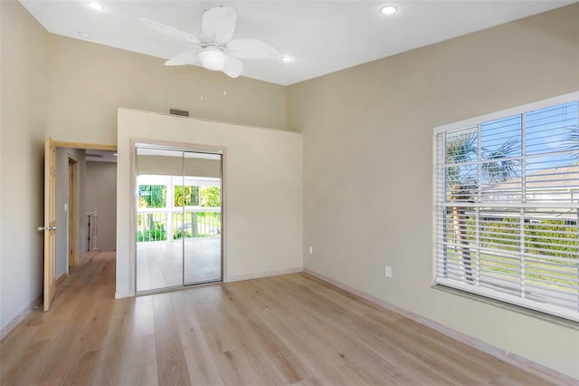 empty room with ceiling fan and light wood-type flooring