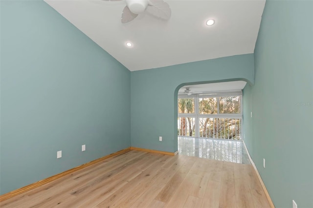 empty room with vaulted ceiling, light hardwood / wood-style floors, and ceiling fan